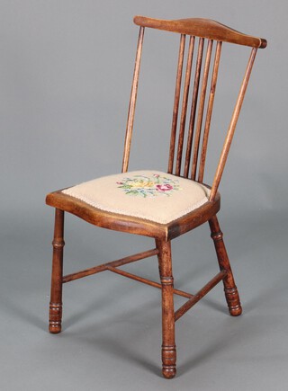 An Art Nouveau bleached beech stick and rail back bedroom chair with Berlin woolwork seat, raised on turned supports with H framed stretcher 75cm h x 38cm w x 33cm d 