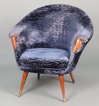 A 1950's tub back armchair upholstered in blue material, raised on turned beech supports with metal caps 77cm h x 83cm w 