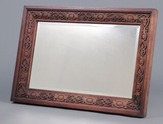 A Victorian bevelled plate mirror contained in a carved oak frame 82cm x 57cm 