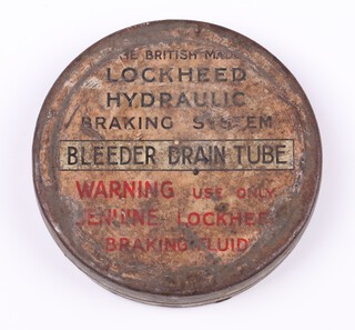 A Lockheed hydraulic braking system bleeder drain tube in a circular metal tin 7.5cm