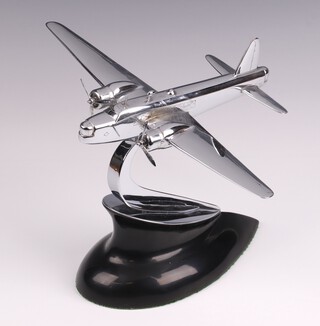 A polished chrome model of a Vickers Wellington Bomber in flight with rotating propellers, on a shaped black acrylic base, visible on Sir Barnes Wallis' desk in public photos 16cm h x 20cm w x 26cm d 