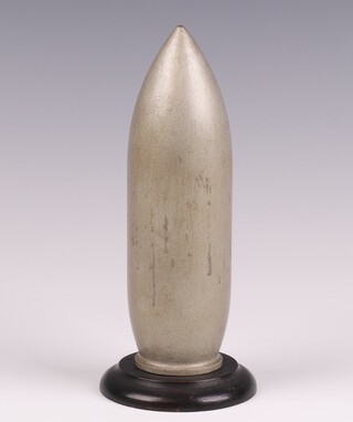 A wooden model of The Grand Slam Bomb (medium capacity) 22,000 LB (10,000 kilogrammes earthquake bomb) raised on a turned wooden stand 17cm x 7cm.  The Grand Slam was the second bomb Wallis designed after the success of the bouncing bomb.  The bomb was even larger than the Tallboy and there was still no aircraft capable of lifting it to its optimal altitude.  Like the Tallboy it could be dropped from a lower height and would enter the earth at near supersonic speed, penetrating to a depth of up to 20m before exploding.  The Grand Slam was also used on strategic German targets such as V-2 rocket launch sites, the V-3 supergun bunker, submarine pens and the battleship Tirpitz, as well as large civil constructions such as viaducts and bridges.