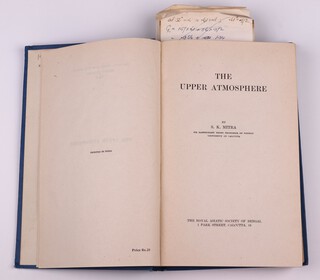 MITRA S. K. The Upper Atmosphere, Royal Asiatic Society of Bengal Calcutta 1948, endpaper signed B.N. Wallis, 8vo, 616pp. Original blue cloth gilt and black lettering, some minor rubbing to edges of corners and spine.  4 Wallis bookmarks offering thoughts and corrections