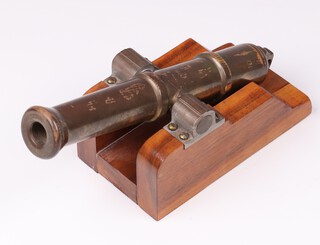 A table cannon with 19cm gilt barrel, raised on hardwood carriage 6.5cm h x 13cm w x 7cm d. 