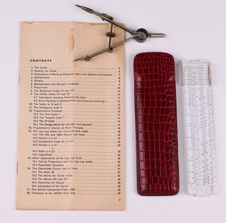 A 1960's slide rule by Graphoplex Brevete S.G.D.G, the reverse stamped SVENSKA DIAMANTBERGBORRNINGS AB, 15cm x 3cm, contained in a red leather case, a pair of steel drafting compasses 11cm and a The Aristo Studio slide rule instruction manual (missing front page, folded and with light staining)
