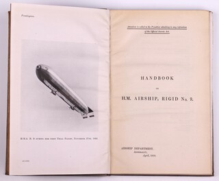 Handbook on H.M. Airship, Rigid No. 9. Admiralty Department 1918, 8vo., 75pp. Bound in blue cloth with debossed white text. Fading to spine and cover, minor rubbing to corners and edges of spine.   Photos, diagrams and fold out coloured plates throughout.  Signed B.N.Wallis to endpaper and stamped 135, pastedown with glued confidential Government statement