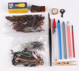 The contents of Sir Barnes Wallis' desk including a collection of paper clips, pens, rubber bands and a clicker etc