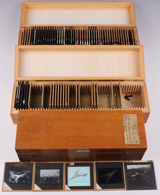 A collection of Barnes Wallis' lecture slides mainly about Aircraft, Strategic Maps and Technical Data in fitted numbered wooden boxes (97 slides, in 3 boxes) 
Box A, 49 slides (1 cracked)
Graphs mainly relating to aircraft performance, including supersonic. Some relate to WW2 explosives, like the Grand Slam 10 ton bomb 

Box K, 26 slides (warped box; 1 slide cracked) 
Slides 1-4 Photos and sketches of Swallow 
Slides 6-7 Photos of Jet aircraft 
Slides 9-18 Photos of flow patterns 
Slide 20 Photo of three-engined flying boat 
Slide 22 Photo of German WW2 flying bomb (doodlebug) 
Slides 24-29 Unknown photos, possibly radar carried by aircraft 
Slides 31-32 Miscellaneous photos

Box L, Maps and Air Routes, 22 slides (2 slides broken)
Range of Wellington Bomber. range of tactical missiles. 
Maps of playing fields, Middle East RAF bases 1929-1956, UN voting groups, non-centrality of New York. 
World maps based on various strategic cities, including London. London to Melbourne mail routes, by sea and by air (probably 1930s). 
1969 world map: spot the gaps in our defences ... when the carriers are gone. 