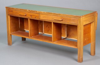 A 1930's rectangular oak drop flap office table with green writing surface, fitted 2 drawers and 3 recesses 77cm h x 168cm w x 52cm d (when folded down) 79cm d (flap open)