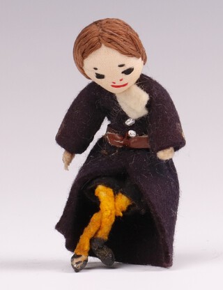 A felt figure of a seated Christ's Hospital pupil in uniform 6.5cm.  
