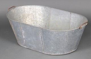 An oval bevelled metal bath 30cm h x 89cm l x 52cm w 