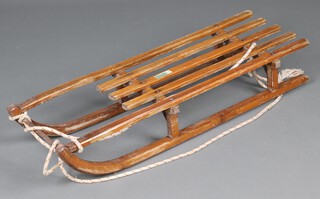 A wooden and metal toboggan marked Grays of Cambridge 18cm h x 100cm l x 31cm w