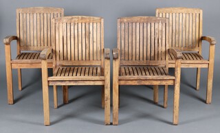 Four slatted hardwood open arm garden chairs 
