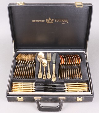 A Bestecke Solingen 70 piece canteen of gold plated flatware for 12 and including a flan lifter, 3 serving spoons, soup ladle, sauce ladle, pair of tongs, jam spoon and 2 pastry serving forks, all contained in a briefcase 