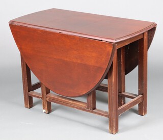 A 1930's oval mahogany drop flap gateleg dining table 71cm h x 106cm w x 51cm  