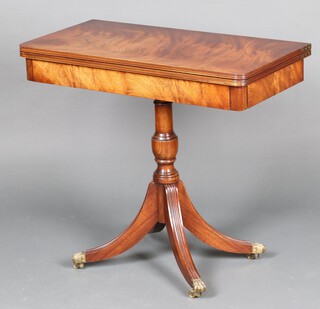 A Georgian style card table raised on turned column and tripod base ending in brass paw feet 76cm h x 85cm w x 43cm d 