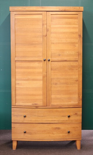 An oak bow front wardrobe, the base fitted 2 drawers on square supports 169cm h x 101cm w x 60cm d 