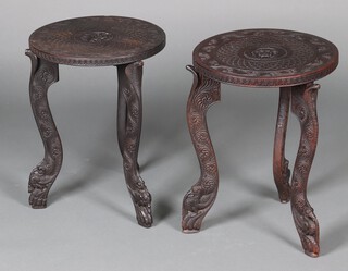 A circular carved hardwood occasional table on cobra supports 50cm h x 38cm diam. and a similar table the centre carved flower head 51cm h x 38cm 