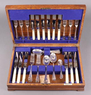 A 42 piece canteen of silver plated Old English rat tail pattern cutlery (1 knife handle damaged) in an oak box marked Harrods Ltd. 