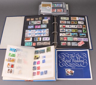 A blue ring bound album of mint and used stamps Elizabeth II, a stock book of world stamps and a collection of presentation stamps  