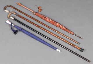 An ebony walking cane with silver handle, 2 walking canes with silver band and silver handle, together with 2 parasols