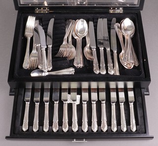 A 64 piece of matched silver plated flatware comprising 10 dinner knives, 9 forks, 10 pudding knives, 11 forks, 7 soup spoons, 4 serving spoons, 7 table spoons, 7 tea spoons, 3 unmatched soup spoons and 2 forks, contained in an ebonised canteen with drawer 