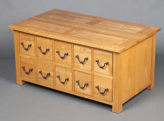 An oak chest of 10 short drawers with iron swan neck drop handles 51cm h x 104cm w x 61cm d 