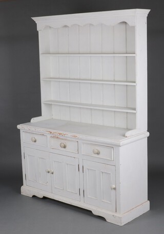A white painted pine dresser with raised back fitted 3 shelves, the base with 3 drawers above triple cupboard 201cm h x 141cm w x 48cm d 