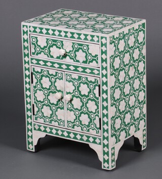 A Moorish style green and white cabinet fitted a drawer above panelled doors 60cm h x 45cm w x 30cm d 