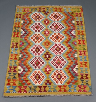 A yellow and turquoise ground Chobi Kilim rug with 2 rows of 12 octagons to the centre 154cm x 98cm 