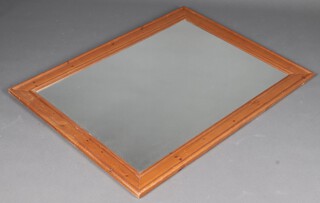 A rectangular plate mirror contained in a pine frame 127cm x 93cm 