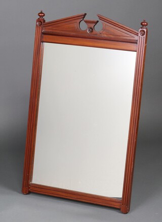 An Edwardian rectangular plate mirror contained in a walnut frame with broken pediment and fluted columns to the sides 91cm x 57cm