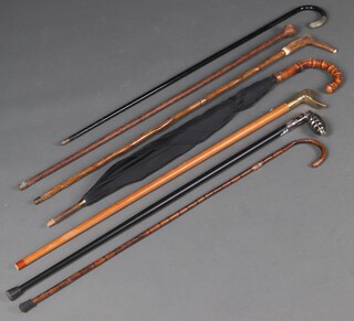A collection of walking sticks and an umbrella 