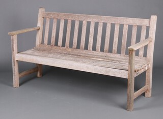 A slatted wooden garden bench 84cm h x 109cm w x 54cm d  