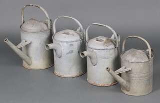Two galvanised, 2 gallon watering cans and 2 Beldray watering cans