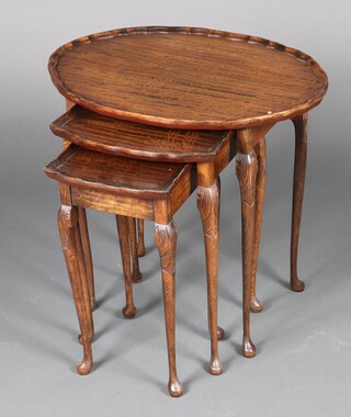 A nest of 3 oval Chippendale style walnut coffee tables, raised on cabriole supports 55cm h x 60cm w x 44cm d 