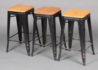 Three black painted pressed metal and pine stacking stools 66cm h x 30cm w x 30cm d 