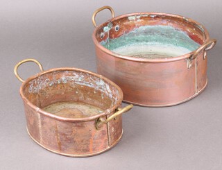 Two oval copper twin handled planters 8cm h x 20cm w x 16cm d and 12cm h x 24cm w x 23cm d 