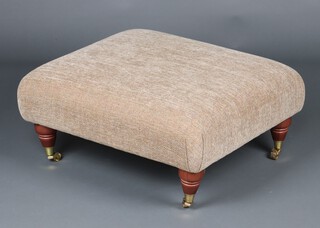 Parker Knoll, a Victorian style ottoman/stool, raised on turned supports ending in brass caps and casters 30cm h x 64cm w x 67cm d  
