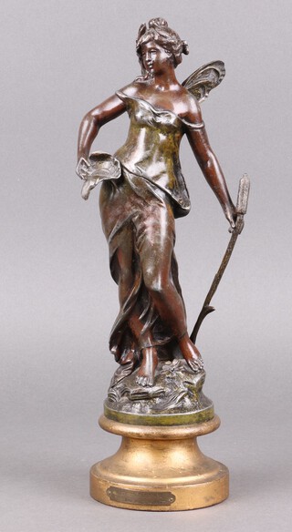 After Auguste Nomoreau, a spelter figure of a standing lady on turned wooden base 35cm  