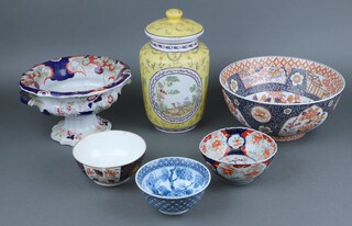 A 20th Century Imari style bowl 13h x 30diam., an ironstone Imari pattern twin handled tureen (cracked), a modern Chinese yellow glazed urn and cover 30h, a Derby style Imari bowl and a Chinese blue and white bowl