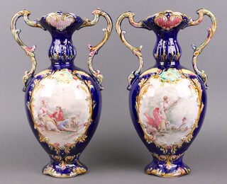 A pair of Edwardian blue glazed pottery twin handled vases with transfer decoration 39cm 