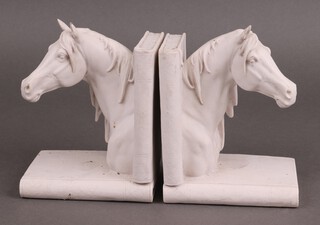 A pair of resin bookends in the form of horses heads 14cm x 12cm x 9cm 