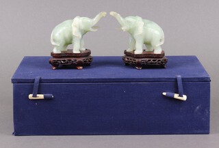 Two green hardstone figures of elephants 6cm in a plush case 