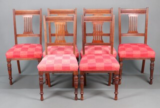A set of 6 Edwardian mahogany stick and rail back dining chairs with overstuffed seats, raised on turned supports (require re-upholstery)