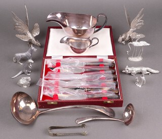 A silver plated cigarette box, 2 silver plated sauce boats, a cased set of horn handled steak knives, 2 silver plated ladles and a collection of plated figures of animals etc