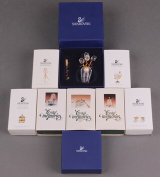A collection of Swarovski Crystal including vase of tulips 6cm, 2 bells and 7 Memories Collection figures including  tankard, rowing boat, globe, carousel, 2 booties, ice skate and a film camera 