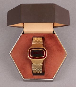 A  Windert digital wristwatch contained in a gilt case, cased