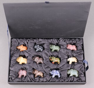 Twelve Eastern carved hardstone figures of elephants 4cm, cased 