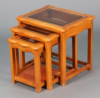 A nest of three "cherry" rectangular interfitting coffee tables with plate glass tops 46cm h x 50cm w x 42cm d